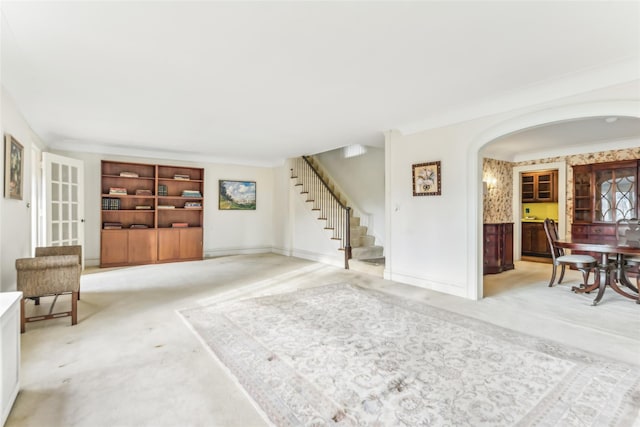 interior space with light carpet and ornamental molding