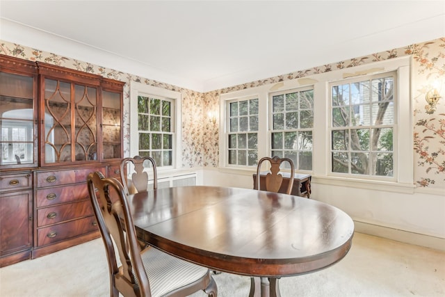 carpeted dining area featuring a wealth of natural light