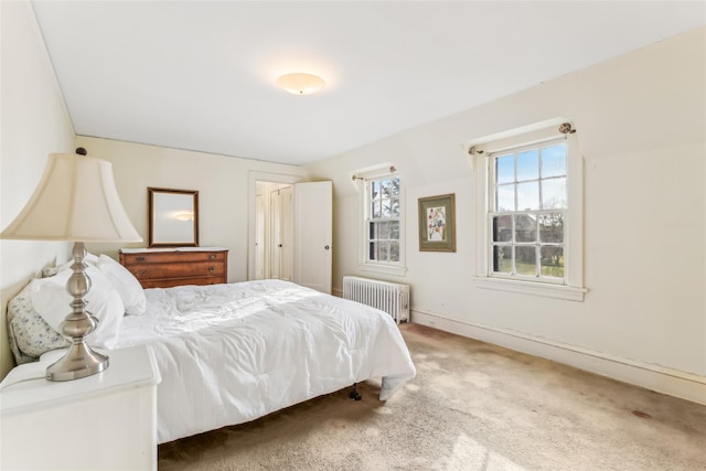 bedroom featuring carpet flooring and radiator heating unit