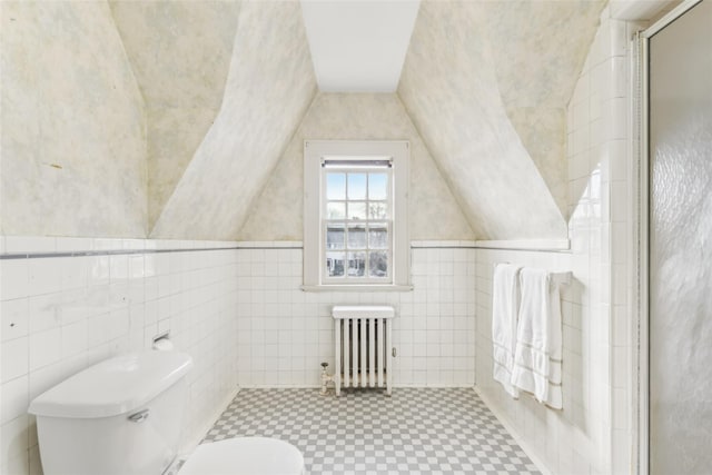 bathroom featuring walk in shower, toilet, radiator, and vaulted ceiling