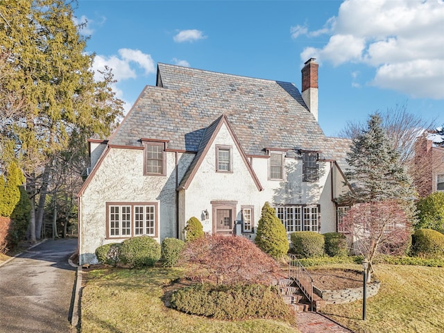 english style home with a front yard