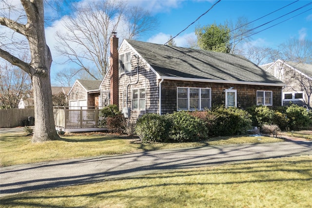 view of side of property with a yard and a deck