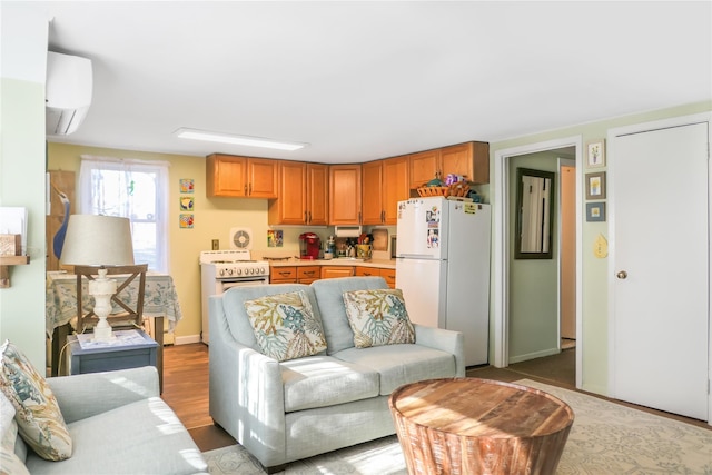 living room featuring hardwood / wood-style flooring and an AC wall unit