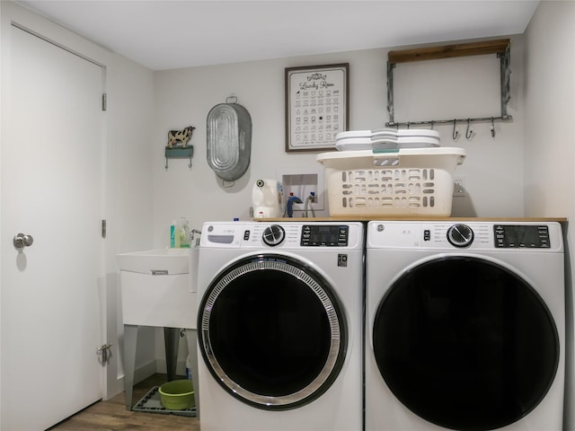 washroom featuring wood-type flooring and independent washer and dryer