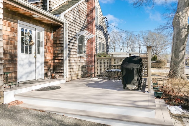 wooden terrace featuring area for grilling