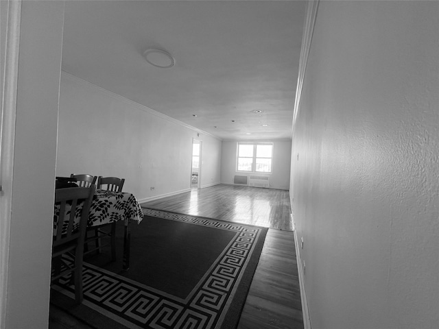 interior space with ornamental molding and dark hardwood / wood-style floors