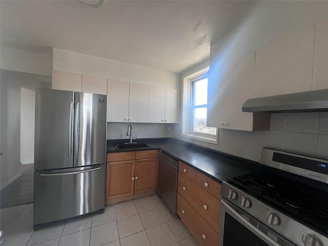 kitchen with extractor fan, light tile patterned flooring, sink, decorative backsplash, and stainless steel appliances