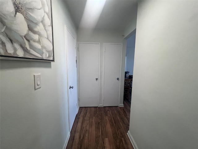 hallway with dark hardwood / wood-style floors