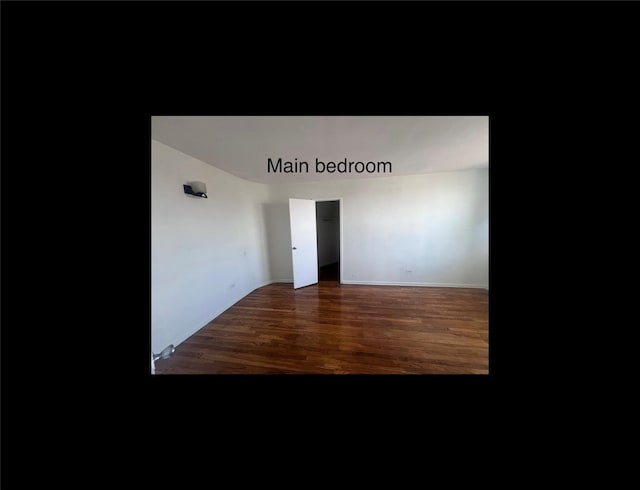 unfurnished room featuring dark hardwood / wood-style flooring