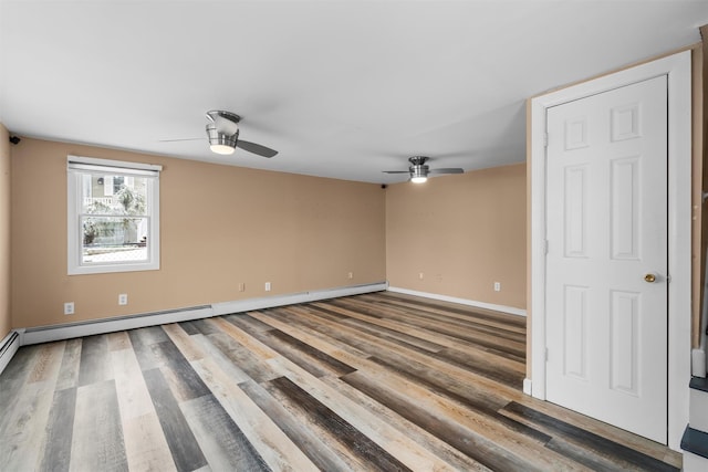 unfurnished room with wood-type flooring, a baseboard heating unit, and ceiling fan