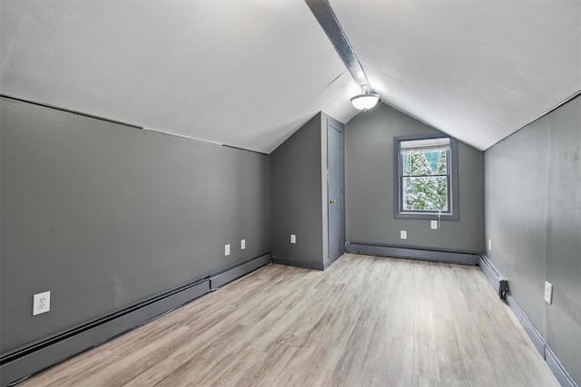 bonus room with a baseboard radiator, lofted ceiling, and light wood-type flooring