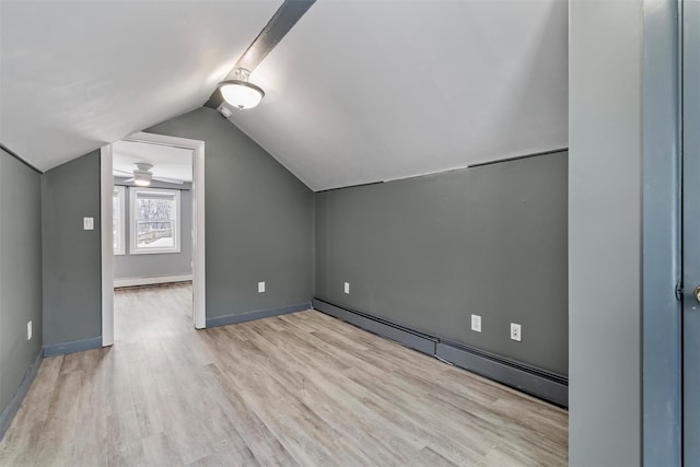 bonus room with a baseboard radiator, light hardwood / wood-style floors, and vaulted ceiling