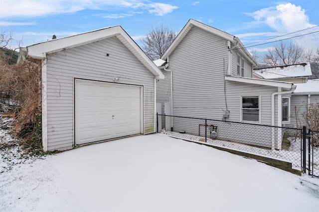 view of snowy exterior with a garage