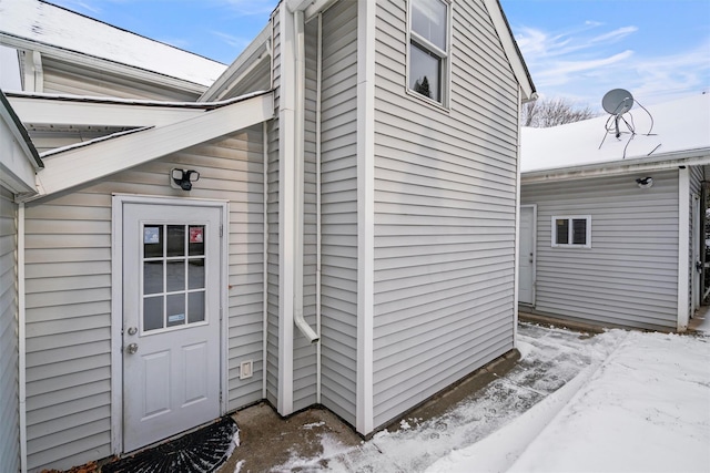 view of snow covered property entrance