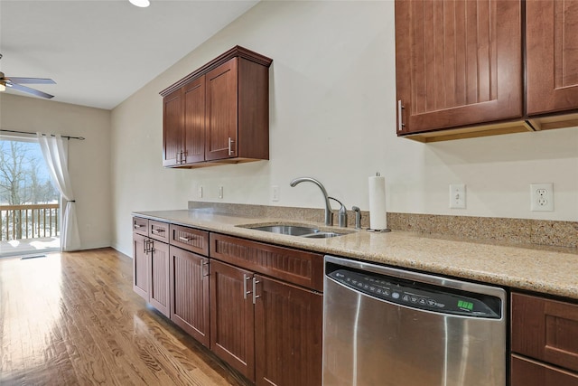 kitchen featuring sink, ceiling fan, light stone counters, light hardwood / wood-style floors, and stainless steel dishwasher