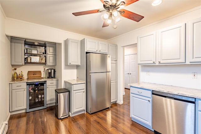 kitchen with light stone countertops, appliances with stainless steel finishes, dark hardwood / wood-style floors, and beverage cooler