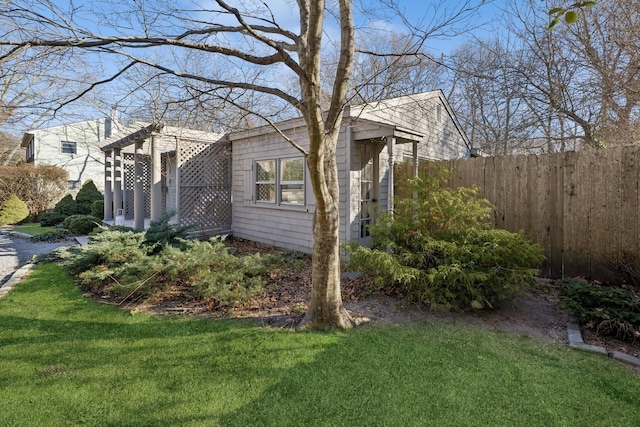 view of side of home featuring a yard