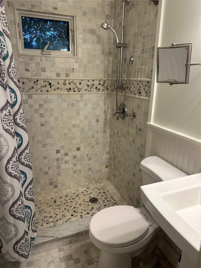 bathroom with walk in shower and toilet