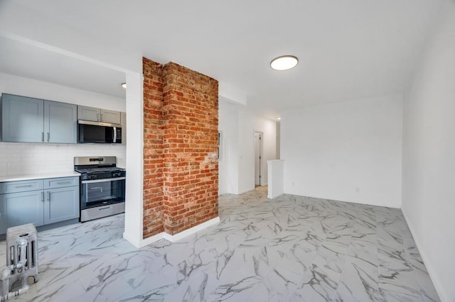 kitchen with stainless steel appliances and backsplash