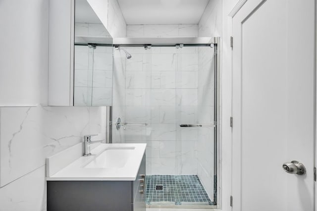 bathroom featuring vanity, tile walls, and walk in shower