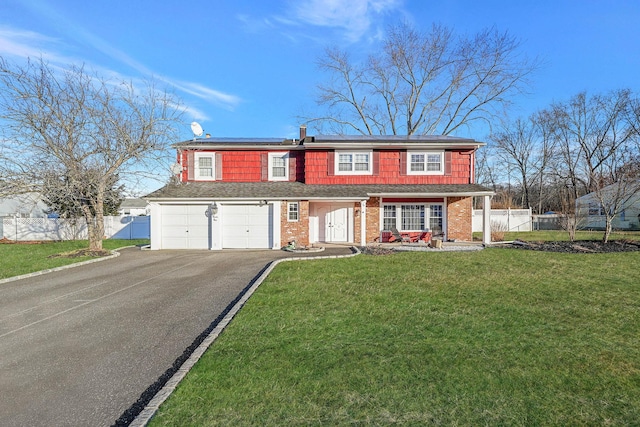 view of front of property with a garage and a front yard