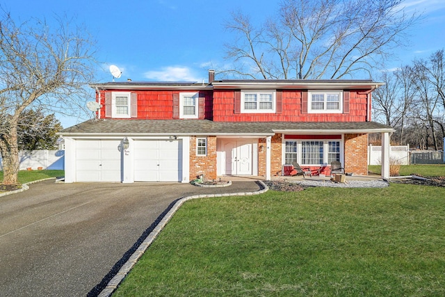 view of front of property with a garage and a front yard