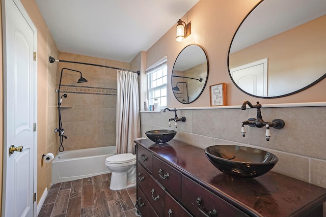 full bathroom with shower / tub combo with curtain, tasteful backsplash, tile walls, hardwood / wood-style flooring, and toilet