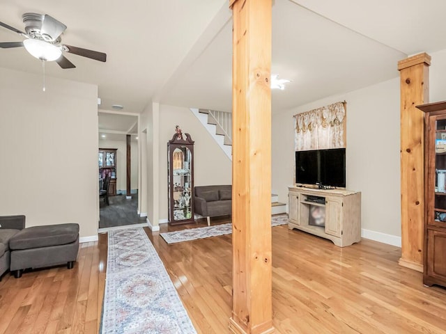 living room featuring ceiling fan and light wood-type flooring