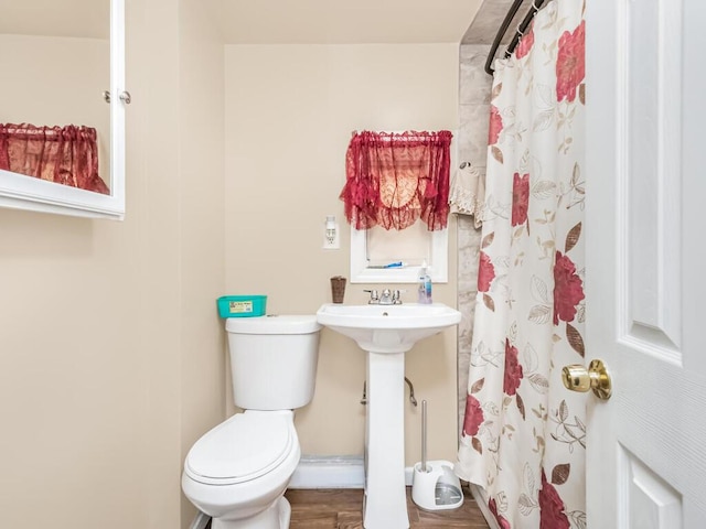 bathroom featuring sink, hardwood / wood-style floors, toilet, and walk in shower