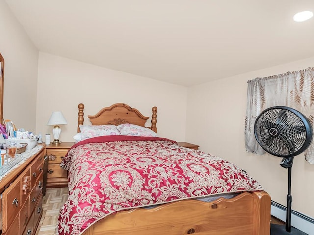 bedroom featuring a baseboard radiator and light parquet floors