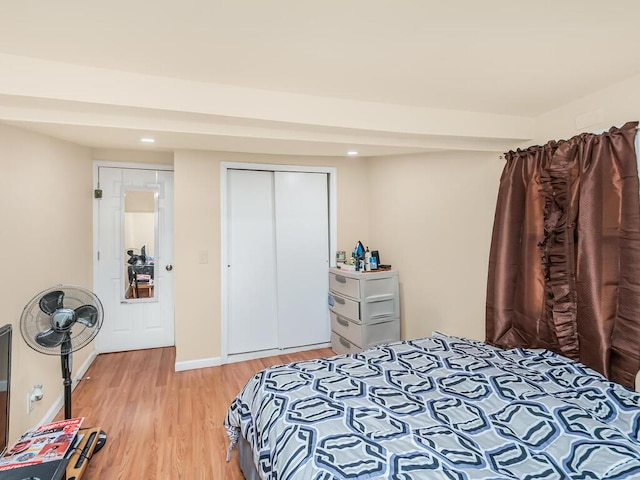 bedroom featuring light hardwood / wood-style flooring and a closet