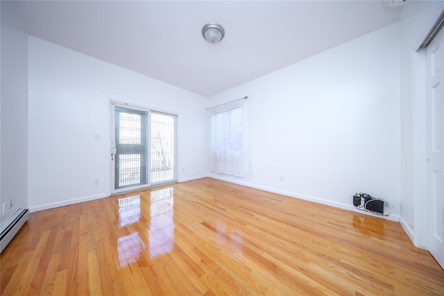 spare room featuring light hardwood / wood-style flooring and baseboard heating