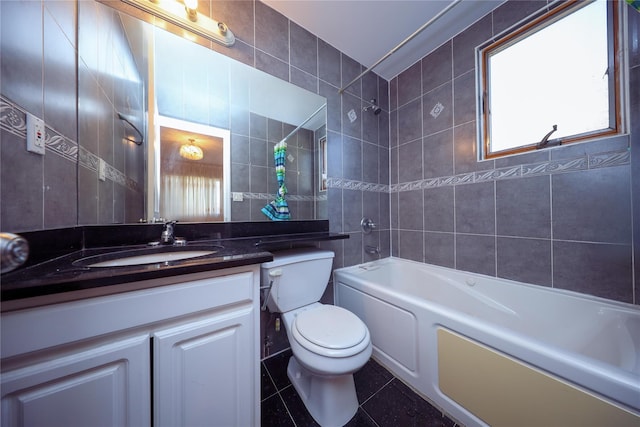 full bathroom with tile walls, vanity, shower / bathing tub combination, tile patterned floors, and toilet