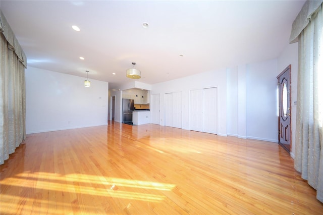 unfurnished living room featuring light hardwood / wood-style flooring