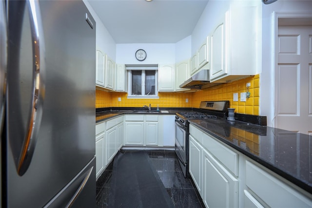 kitchen featuring fridge, white cabinets, decorative backsplash, and stainless steel gas stove