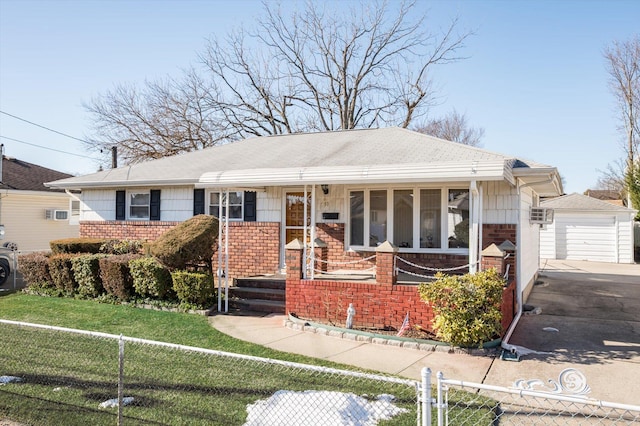 ranch-style home with a garage, an outdoor structure, a front yard, and covered porch