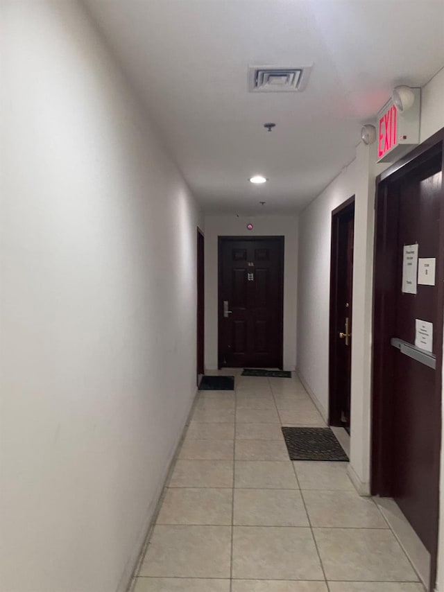 corridor featuring light tile patterned floors