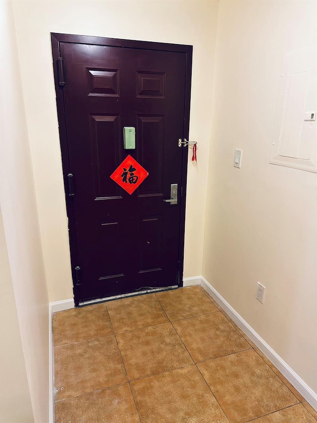 doorway featuring tile patterned floors and electric panel