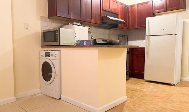 kitchen with white refrigerator, washer / dryer, light tile patterned floors, and backsplash