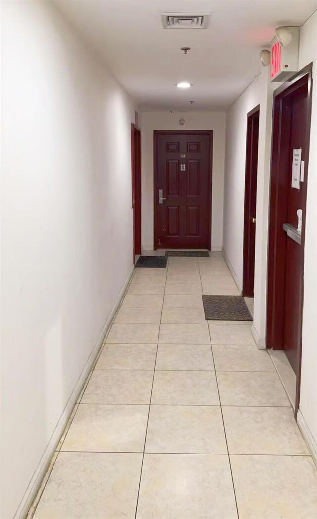 hall featuring light tile patterned floors