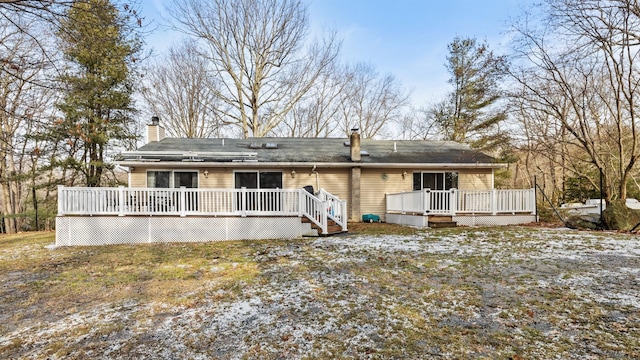 back of house featuring a deck