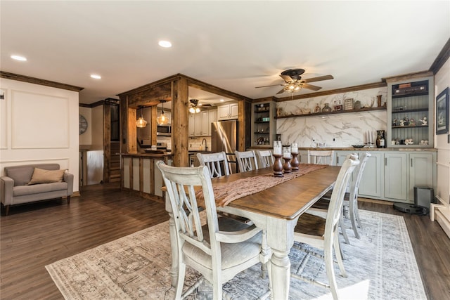 dining space with dark hardwood / wood-style flooring, ornamental molding, and ceiling fan