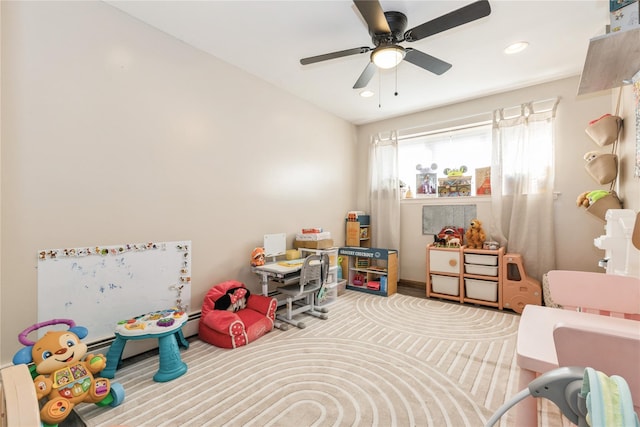 recreation room with carpet floors and ceiling fan