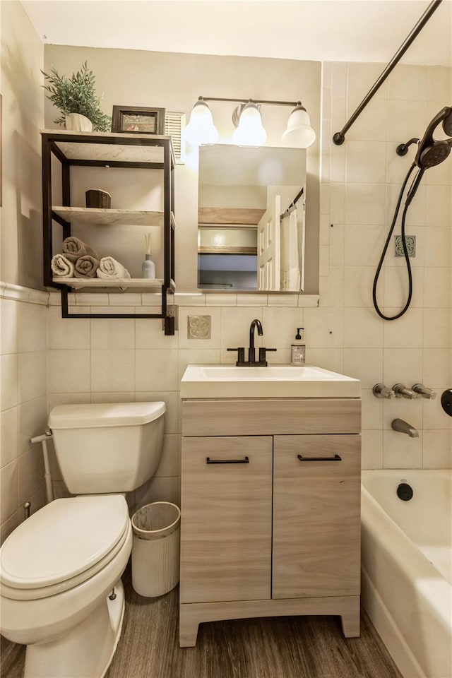 full bathroom with vanity, toilet, wood-type flooring, and tile walls