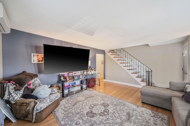 living room with a wall mounted air conditioner and wood-type flooring