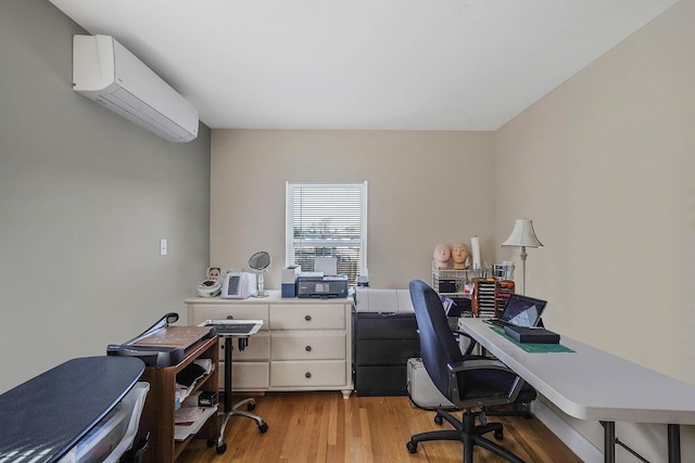 office space featuring light hardwood / wood-style floors and a wall unit AC