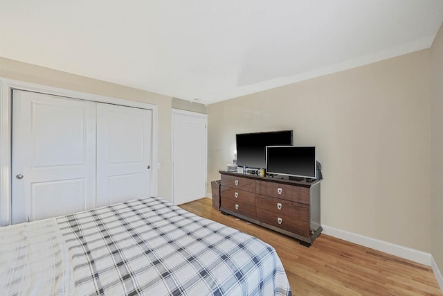 bedroom featuring a closet and light hardwood / wood-style flooring