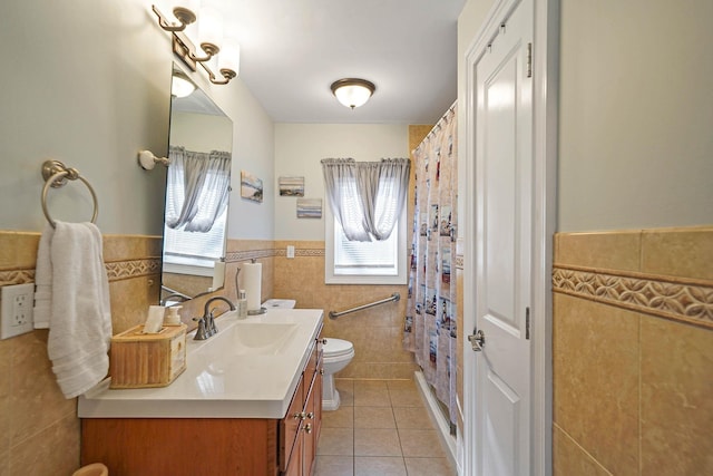 bathroom featuring tile walls, vanity, tile patterned floors, and toilet