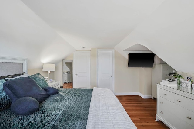 bedroom featuring dark hardwood / wood-style floors and vaulted ceiling