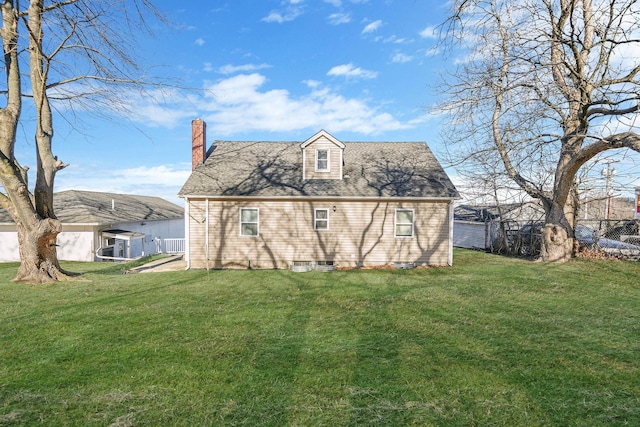 back of house with a lawn